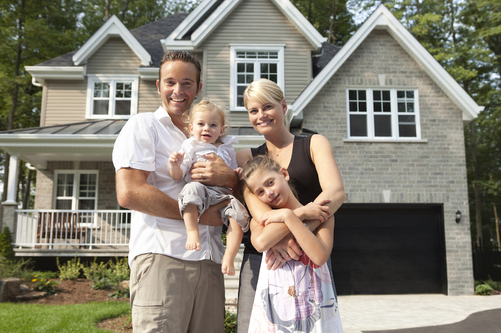 home-with-happy-family happy family in front of house